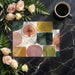 Chic dining room with an earthy watercolor fruit mural wallpaper behind a light oak table.