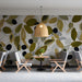 Bright restaurant space with nature-inspired botanical wallpaper accent wall