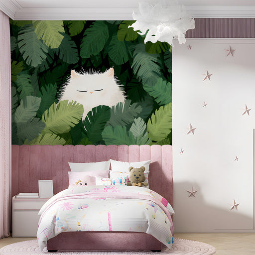 A cozy bedroom with a white cat and jungle leaf mural behind a minimalist beige headboard.