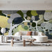 Modern living room featuring an abstract forest canopy mural behind a low-profile walnut bed.