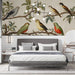 A bright, sun-drenched bedroom featuring a classic botanical bird wall mural behind a simple iron bed frame