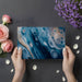 Contemporary home office with blue abstract mural wallpaper creating a calm, creative backdrop.