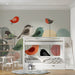 Bright bedroom area with a playful avian mural wallpaper providing a cheerful focal point