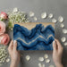 Modern bedroom wall with flowing navy marble mural creating a calming focal point