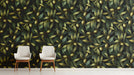Moody entryway with olive branch wallpaper on a statement wall behind a wooden table