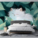 Cheerful bedroom with a playful white cat and green leaves mural on the primary accent wall