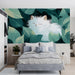 A cozy bedroom with a white cat leaf wallpaper feature wall behind a light oak wooden bed frame
