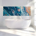 Bathroom feature wall featuring abstract blue liquid art mural behind a grey velvet sofa