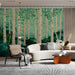 A cozy living room with a green aspen forest wallpaper behind a wooden bed frame.