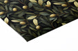 Home library wall with dark botanical olive branch wallpaper and leather armchair
