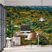 A modern study with a large terraced mountain mural behind a minimalist velvet sofa.