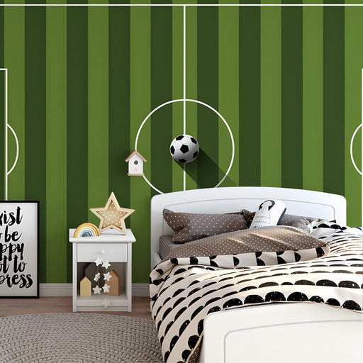 Football pitch wall mural installed in a modern boy's bedroom with gray furniture