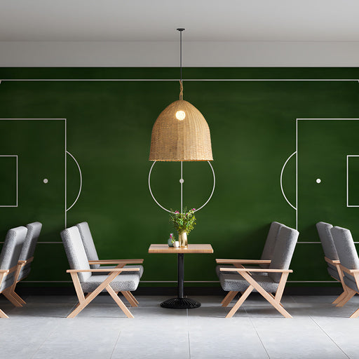 Sport themed cafe wall featuring a soccer pitch mural
