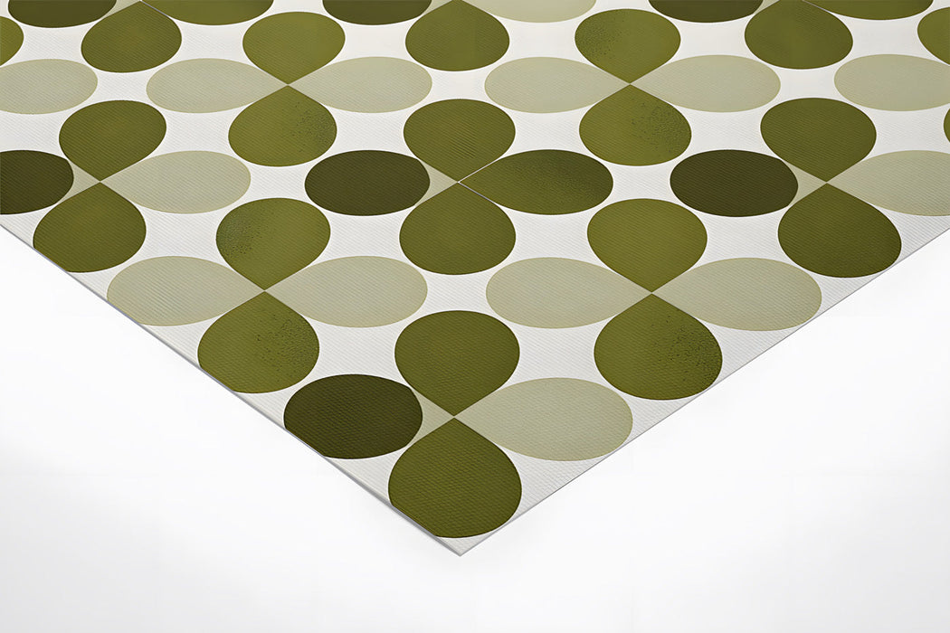 A sophisticated home office space with the green geometric wallpaper behind a minimalist wooden desk.