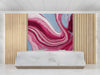 A contemporary reception featuring a bold marble swirl mural on the main accent wall behind a velvet sofa.