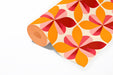 Bold floral grid pattern wallpaper in a vibrant, sunlit breakfast nook