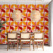 Fun and energetic geometric mural wallpaper applied in a creative dining room space