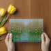 Whimsical botanical wallpaper in a modern home office space with desk and shelving