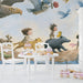 The storybook wildlife mural installed in a charming nursery with soft wooden crib and neutral decor.