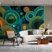 Home office space featuring a tactile abstract mural with blue and green circular patterns on the main wall