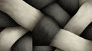 Close-up of a woven texture pattern with charcoal and ivory ribbons