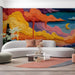 Living room interior with a colorful painterly landscape mural as a focal point.