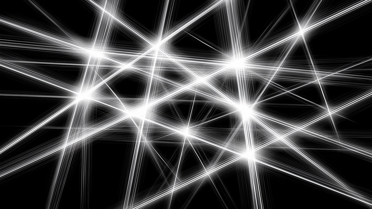 Abstract pattern of intersecting white light beams on a solid black background.