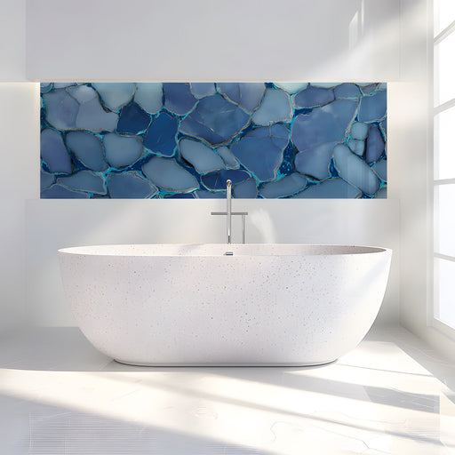 Contemporary bathroom decorated with a vibrant blue mosaic mural and minimalist light wood furniture.
