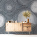A sophisticated bedroom space showcasing a fluid gray swirl wallpaper design as an accent wall.