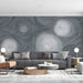 A modern living room featuring a swirling gray line art feature wall behind a minimalist velvet sofa.