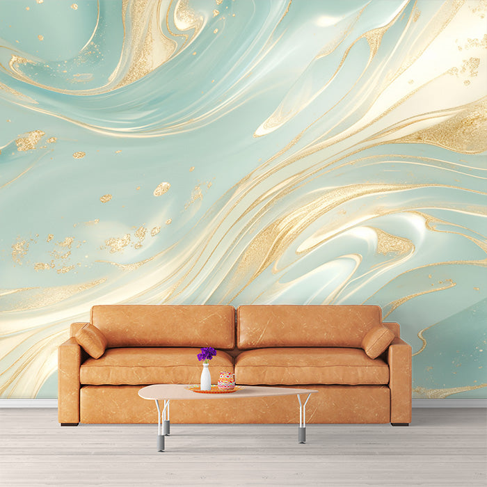 A room with turquoise and gold swirl mural wallpaper featuring light turquoise background with flowing gold lines and splatters, a brown sofa, and a white coffee table in the foreground.