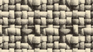 Close up of a woven basketry pattern in monochrome cream and charcoal tones