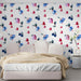 A cozy bedroom featuring a white crib and the delicate floral heart mural wallpaper.