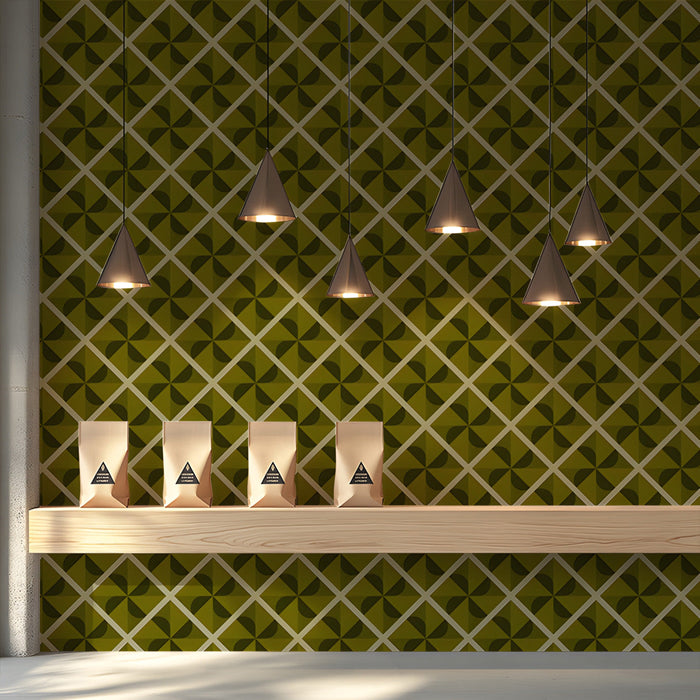 A refined shop interior featuring an olive green geometric wallpaper mural behind a headboard.