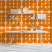 A cozy kitchen study with retro orange grid wallpaper styling.