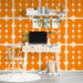 Mid-century modern study with a bold orange patterned accent wall.