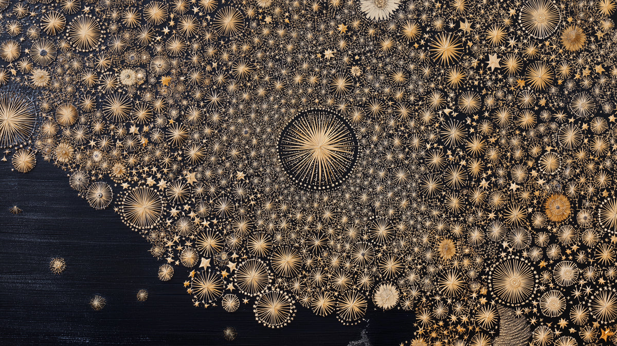 Intricate celestial pattern featuring gold straw-like sunbursts and star motifs against a deep charcoal background.