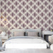 Repeating patterned wallpaper featured in a stylish, minimalist bedroom.