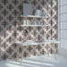 Geometric floral wallpaper installed on the main wall of a cozy modern study