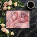 A minimalist home office with a blush pink rose mural serving as a sophisticated focal point.