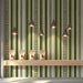 Striped olive green botanical wallpaper featured in a cozy shop with wooden furniture