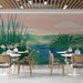A serene bar wall covered in a painterly wetland mural with soft pastel sunset tones.