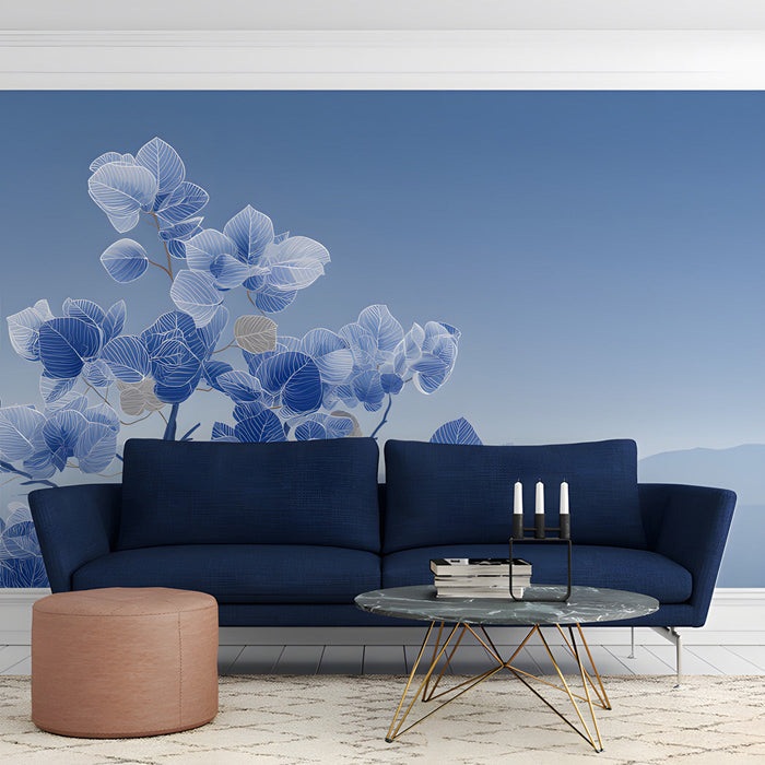 Minimalist study with blue foliage mural behind a light oak bed frame
