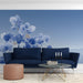 Minimalist study with blue foliage mural behind a light oak bed frame