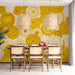 Contemporary dining room with a sun-inspired yellow circle mural behind a sofa