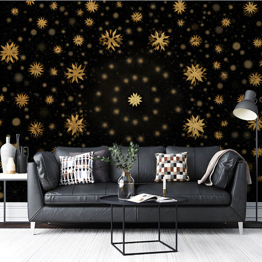 A sophisticated  living room featuring the black and gold stellar wallpaper behind a plush velvet headboard.