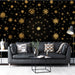 A sophisticated  living room featuring the black and gold stellar wallpaper behind a plush velvet headboard.