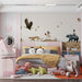 A bright playroom featuring the storybook-style animal mural on a large accent wall.