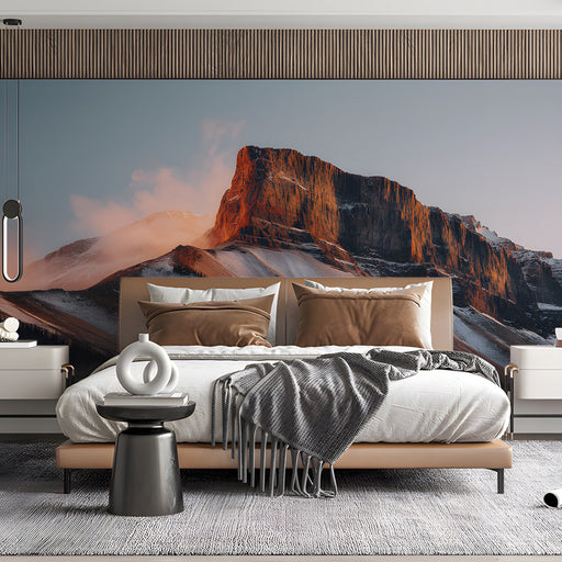 Bedroom interior with a large mountain landscape mural above a modern beige sofa