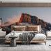 Bedroom interior with a large mountain landscape mural above a modern beige sofa